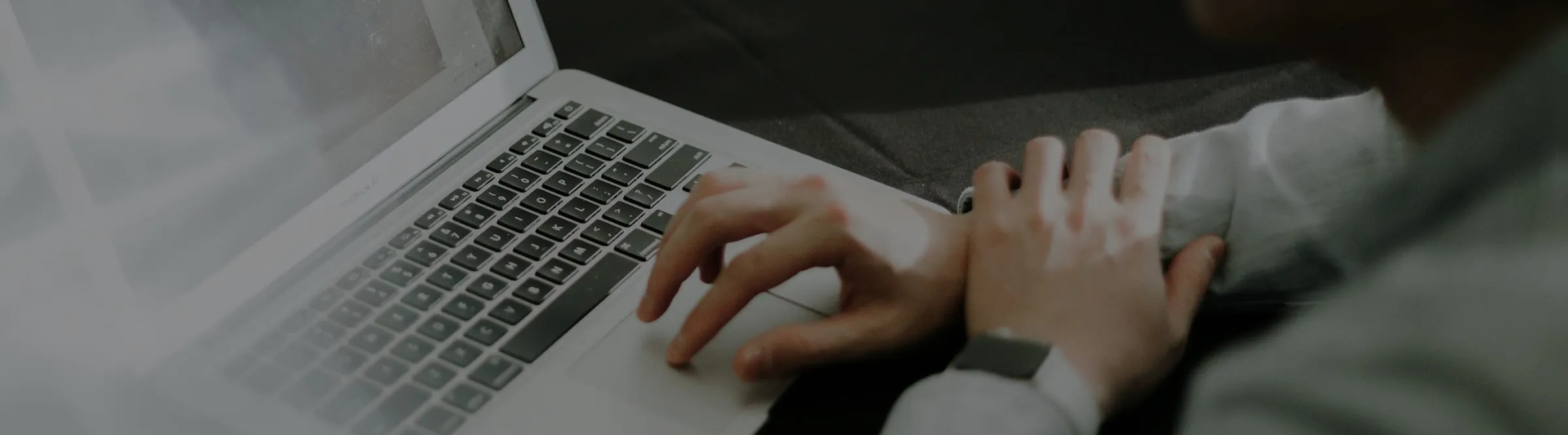 Hands working at a laptop