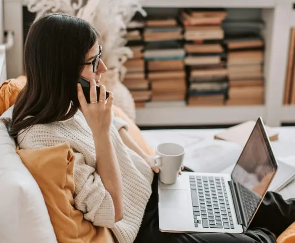 A woman at her desk during a phone conversation